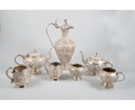 Seven pieces of Indian/ Burmese white metal tea ware, a coffee pot, two teapots, two milk jugs and two open sugars, all heavi