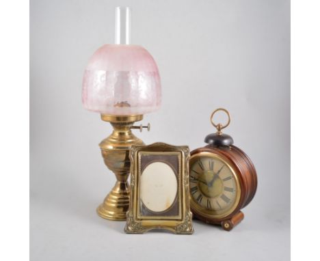 Continental walnut cased alarm mantel clock and two brass oil lamps; two photograph frames. (5)