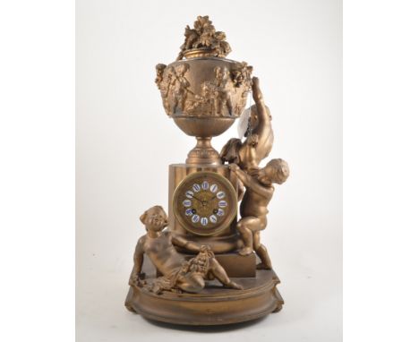 Louis XV style gilt painted spelter mantel clock, covered urn surmount modelled with cherubs, enamelled numerals, cylinder mo