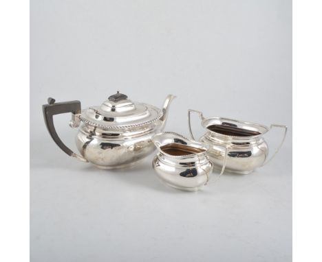 A silver three piece teaset, plain polished oval body with gadroon edge border on a plain oval foot, ebony handle and finial 