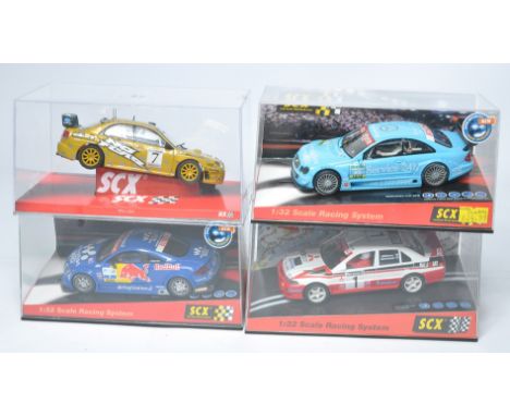 A group of four SCX slot car issues comprising Audi TT-R Red Bull, Subaru Impreza WRC McRae, Mercedes CLK DTM plus Mitsubishi