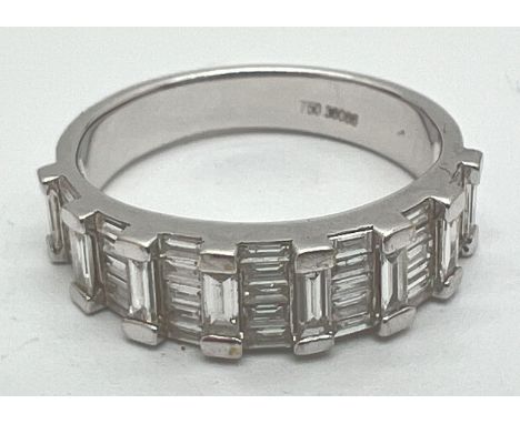 A 18ct white gold half eternity ring set with 43 baguette cut diamonds approx .36ct. Gold marks to inside of band. Ring size 