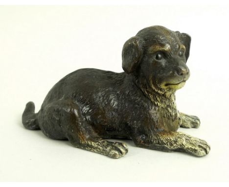 A modern cold painted bronze figure, modelled as a resting dog, in the style of Bergman, bearing marks to base, 5cm high.