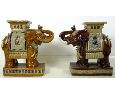 A pair of Chinese style ceramic garden seats, in the form of elephants, in treacle glazes, 55 by 25 by 57cm high. (2)