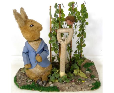 A large automaton of Peter Rabbit in Mr McGregor's garden, mid to late 20th century, 95 by 36 by 77cm high.