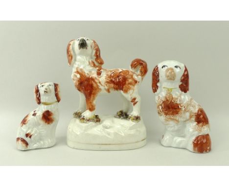 A Staffordshire ceramic figure of a King Charles spaniel, standing with bocage at feet, 13cm, together with two further figur