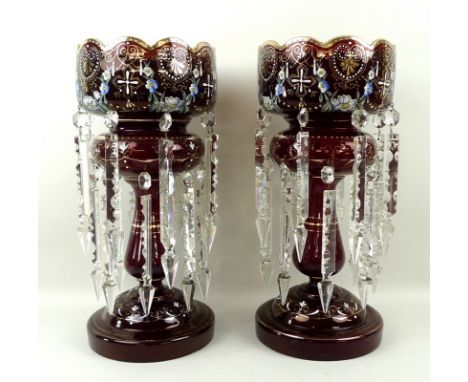 A pair of Bohemian ruby glass lustres, enamelled with floral sprays and hand gilded, circa 1890, each with two rows of eight 