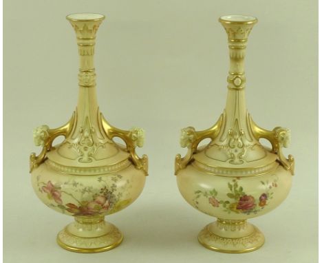 A pair of Royal Worcester blush ivory bottle vases, circa 1894, the handles modelled with rams head masks, the body painted w