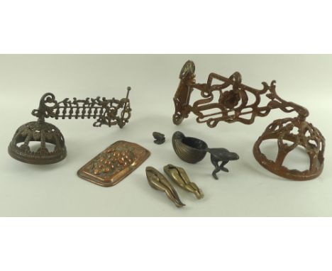 A collection of metalware including two wall mounts for oil lamps, one cast iron, the other brass, two nutcrackers in the for
