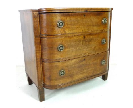 A George IV mahogany, crossbanded and inlaid bow fronted chest of three graduating drawers, with brass ring handles and cock 