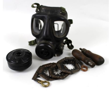 A WWII gas mask together with a WWII chainsaw chain complete in webbing case with four interchangeable handles. (2)