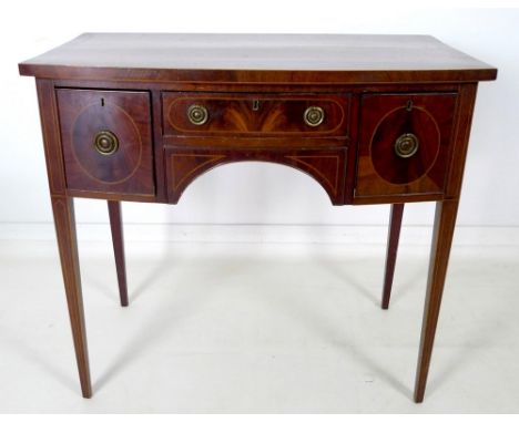 A small Regency style mahogany bow fronted sideboard, with crossbanded top and inlaid stringing, one shallow central and two 