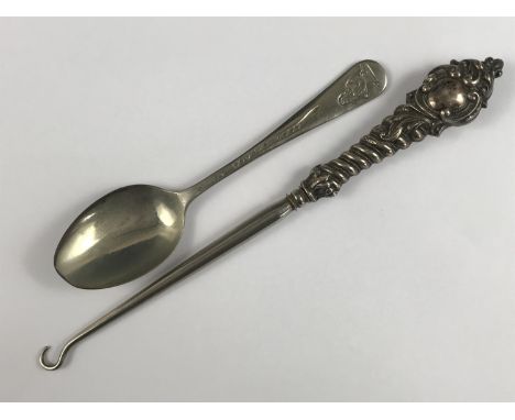 A Victorian silver-handled button hook, and a vintage child's Donald Duck spoon 