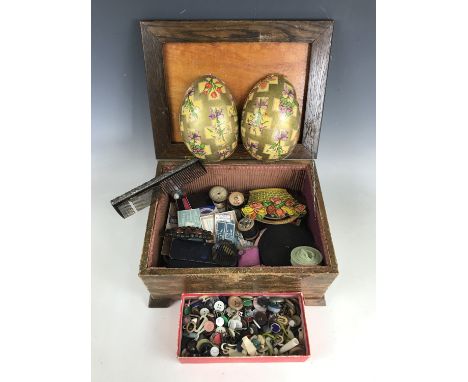 A 1930s sewing casket containing an assortment of period sewing tools and supplies, including a Victorian carton of 'George G
