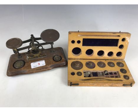 A 19th century set of brass postal scales and weights, together with one further cased set of weights