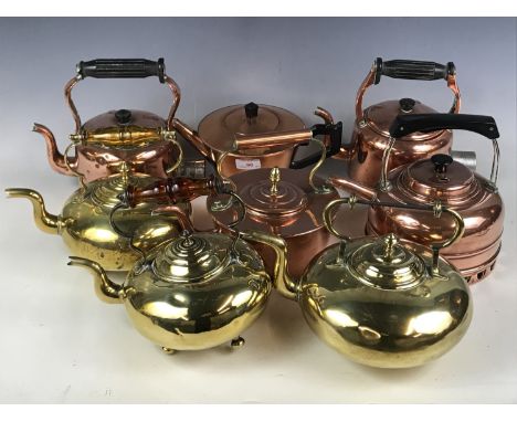 Seven brass and copper kettles together with a teapot