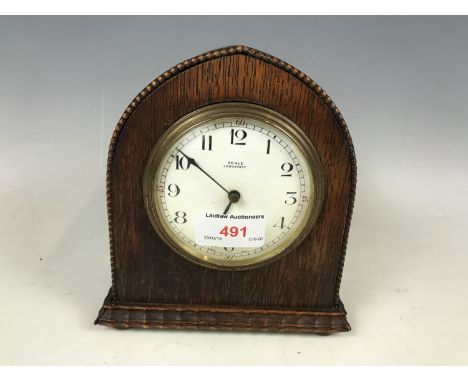 An oak cased mantel timepiece clock retailed by Seale of Lowestoft