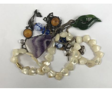 Vintage hardstone jewellery, to include a Blue John cabochon pendant on white-metal chain, a jade pendant, and a mother-of-pe