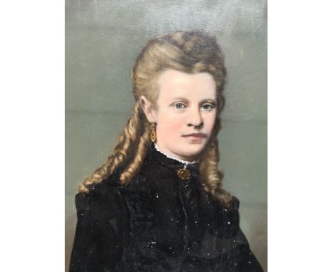 A late Victorian painted photographic portrait of a young girl with ringlets in her hair, bodycolour over photograph, framed 