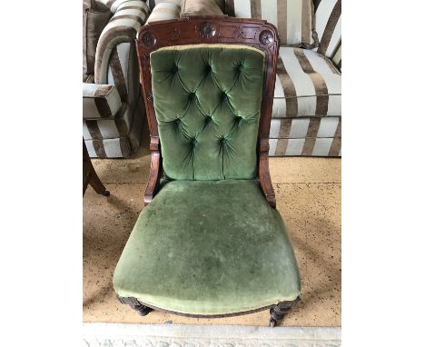 A Victorian button upholstered and carved mahogany nursing chair