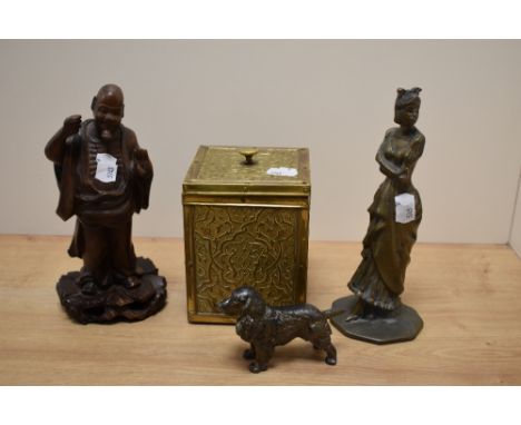 A 20th Century carved hardwood Tibetan monk study, measuring 19cm high, two other figural ornaments included a cast metal spa