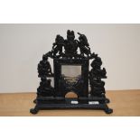 A Victorian cast iron painted door porter in the form of a heraldic miniature fireplace with coat of