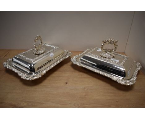 A pair of late 19th/20th Century silver plated and lidded entree dishes of Regency style, each measuring 22cm x 32cm x 15cm