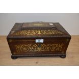 An early 19th Century Regency rosewood work box of sarcophagus form with scrolling brass inlay,