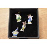 A selection of four early 20th Century miniature enamelled pendants depicting four of the Seven