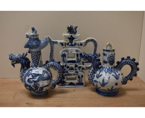 A 19th Century Chinese blue and white dragon ewer, measuring 25cm high, together with two others