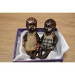 Two miniature bisque porcelain jointed dolls with clothing, the largest measures 8cm high