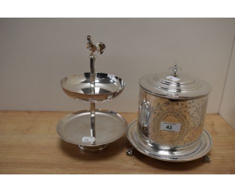 A late Victorian silver plated biscuit barrel, the body engraved with a leaf design and all raised on three claw and ball fee