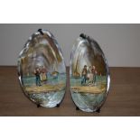 A pair of 19th Century French painted mussel shells, depicting coastal scenes with figures and