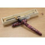 A Conway Stewart 75 lever fill fountain pen in pink marble with single band to the cap having a
