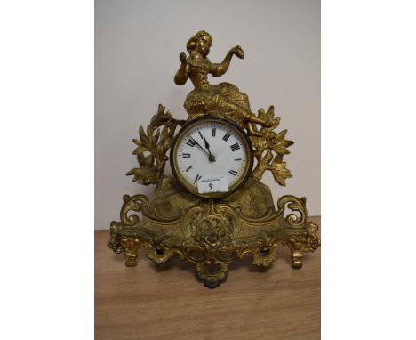 A late 19th Century French gilt metal mantel clock with key, having a figural surmount above an enamelled Roman dial behind g