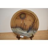 A 20th Century studio pottery plate of Paul Gooderham style, decorated with a stylised landscape