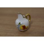A miniature dolls Royal Worcester bone china tusk jug, decorated with foliate sprays and gilt
