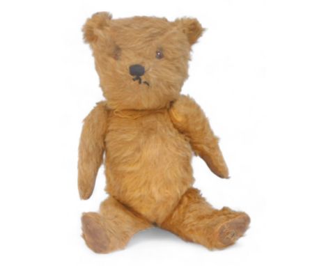 A vintage mohair Teddy bear, with felt pads and articulated arms and legs. 