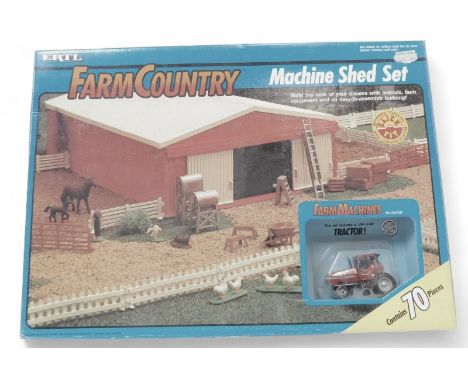An Ertl Farm Country Machine Shed set, with farm machines, tractor, boxed. 