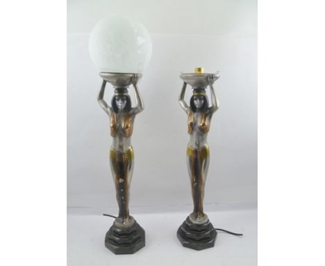 A PAIR OF ART DECO DESIGN EGYPTIAN REVIVAL DESIGN TABLE LAMPS, in the form of caryatid female figures, the one supporting an 