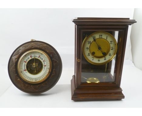 AN EDWARDIAN MAHOGANY CASED MANTEL CLOCK, the circular dial with Arabic numerals, 30cm high, together with a circular carved 