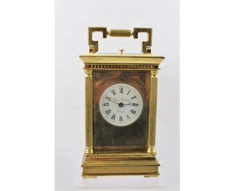 A 20TH CENTURY CHARLES FRODSHAM BRASS REPEATING CARRIAGE CLOCK, having white enamel dial with Roman numerals, engraved face p