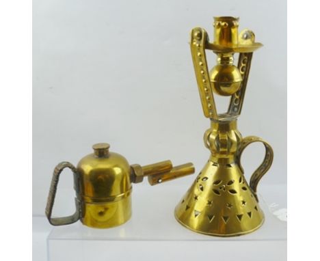 A FOLK ART PIERCED AND EMBOSSED BRASS CHAMBER STICK, with gimbal mounted candle holder and slot to base so that it can be wal