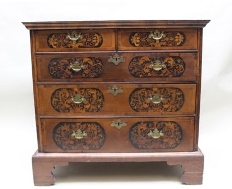AN 18TH CENTURY WALNUT CHEST OF DRAWERS having crossbanded top over two short and three long drawers, marquetry inlaid, fitte