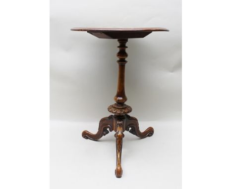 A 19TH CENTURY WALNUT GAMES TRIPOD TABLE, the top inlaid with chequer board and floral decoration, raised on turned stem and 