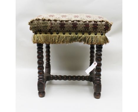A LATE 17TH CENTURY BEECH FRAMED CUSHION STOOL, raised on bobbin turned legs with conforming H-stretchers, fabric upholstered