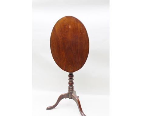 A 19TH CENTURY MAHOGANY OVAL SNAP TOP WINE TABLE, raised on turned stem and tripod supports 