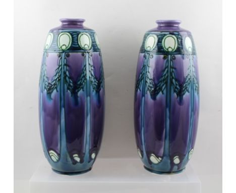 A PAIR OF MINTON SECCIONIST DESIGN CERAMIC VASES, tube lined and painted with swags in blue/green on lavender ground, factory