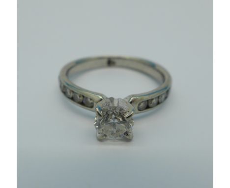An 18ct white gold (tested) and diamond ring, 0.55 carat diamond weight for central stone, hallmark worn, 2.4g, L