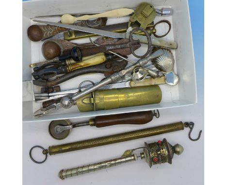 A collection of 19th Century and later implements including cigar cutter, apple corer, ivory nut crackers, caddy spoon, measu